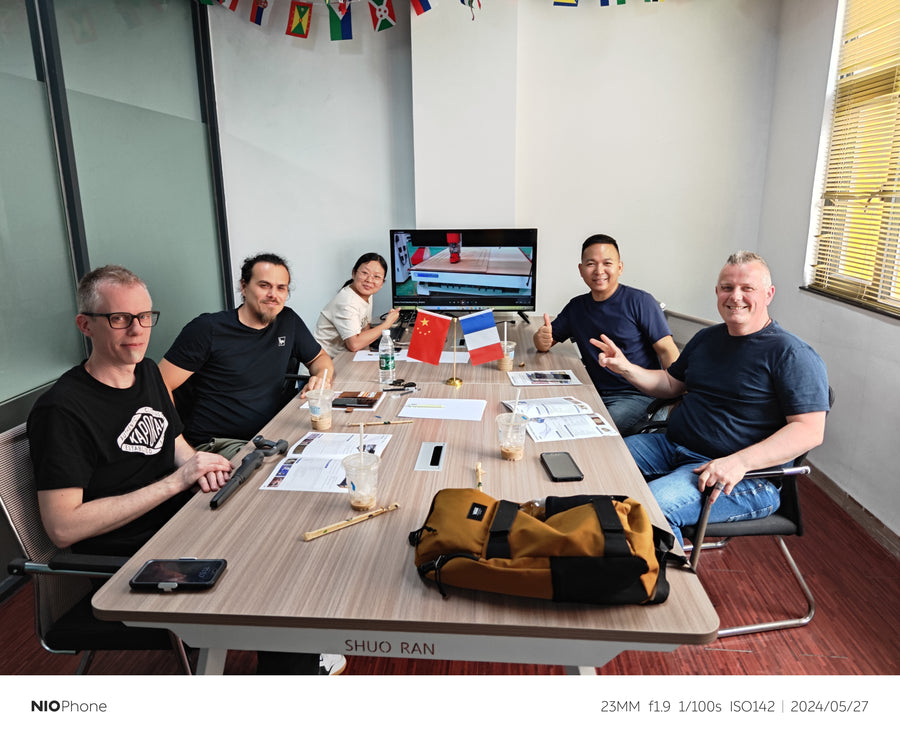 Customers and team members discussing equipment at the meeting table