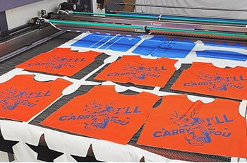 Printed garment panels on a laser conveyor table