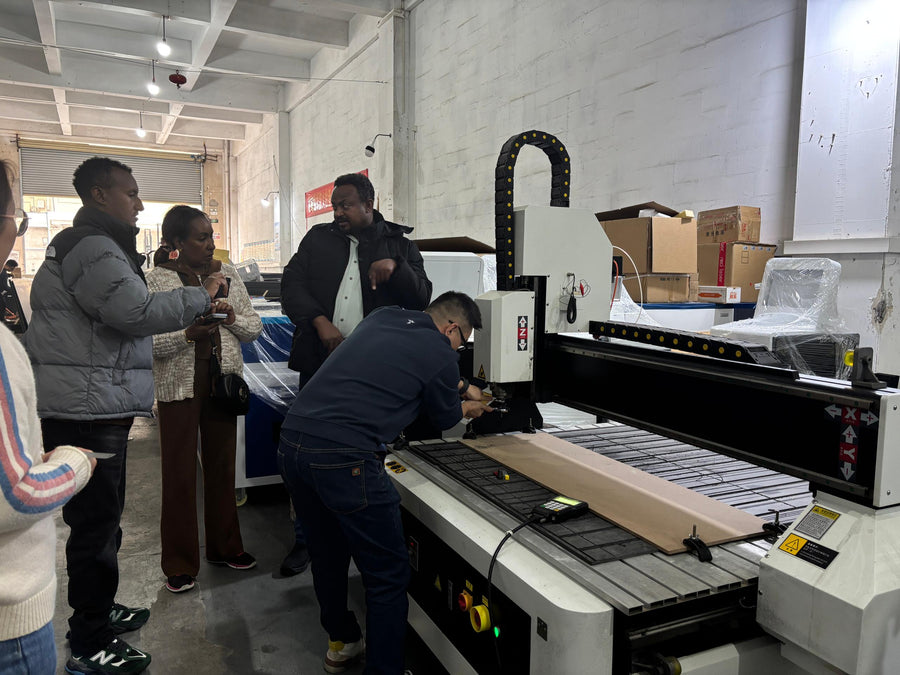 Customers watching a CNC router demonstration