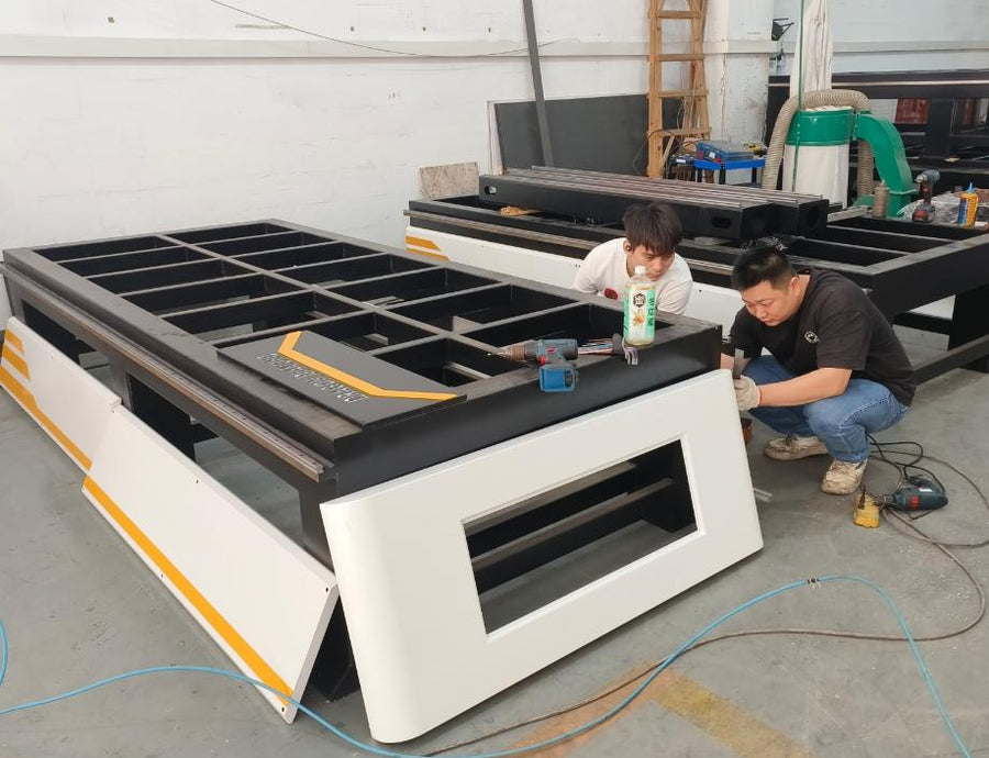 Technicians assembling the machine frame