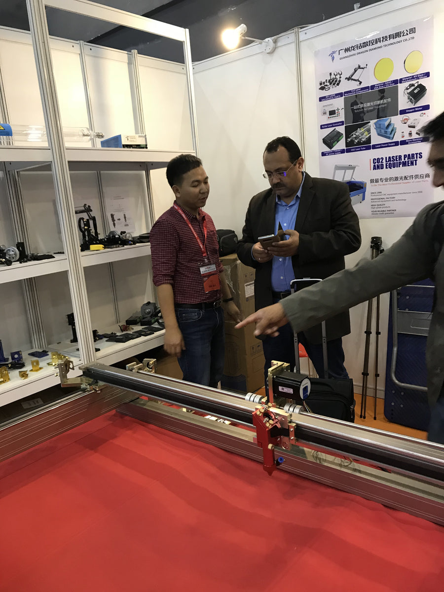Visitors reviewing equipment at an exhibition booth