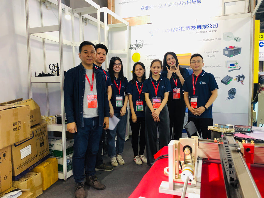 Dragon Diamond team at an exhibition booth with equipment on display