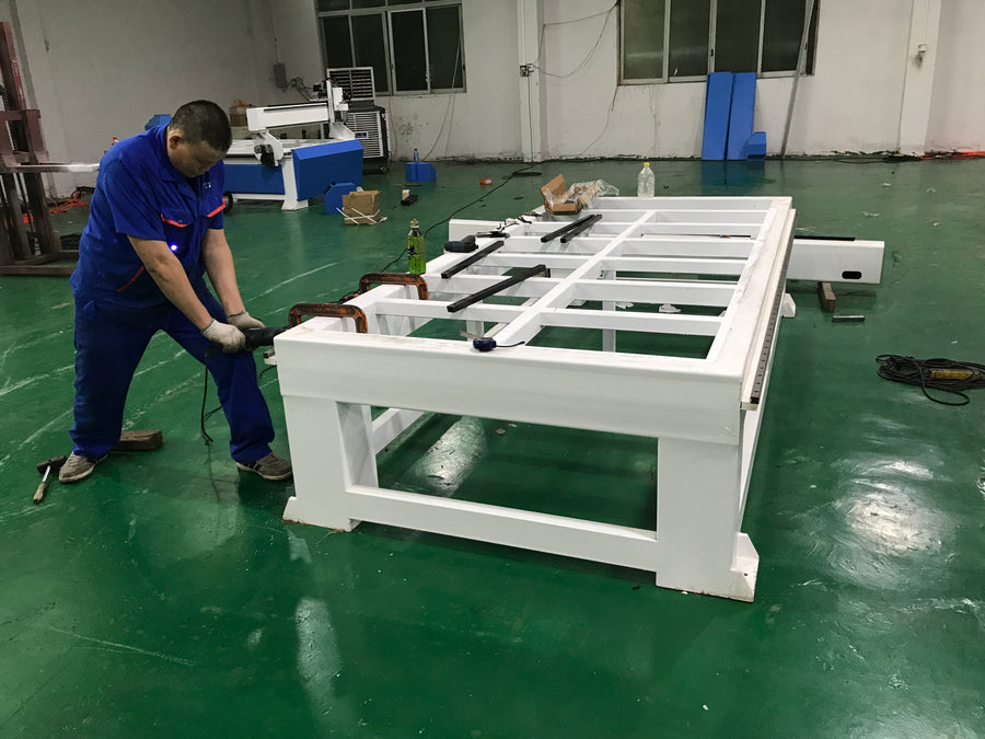 A technician working on a painted machine frame
