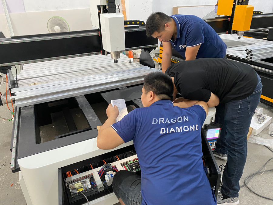 Technicians inspecting the machine bed and internal components