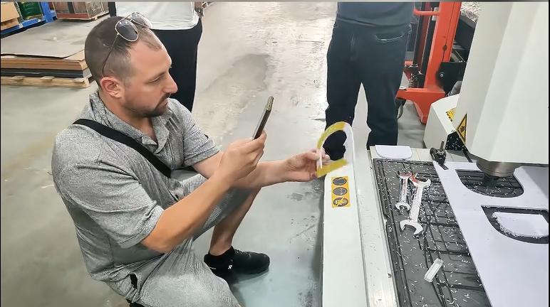 Customer examining a sample beside the CNC router