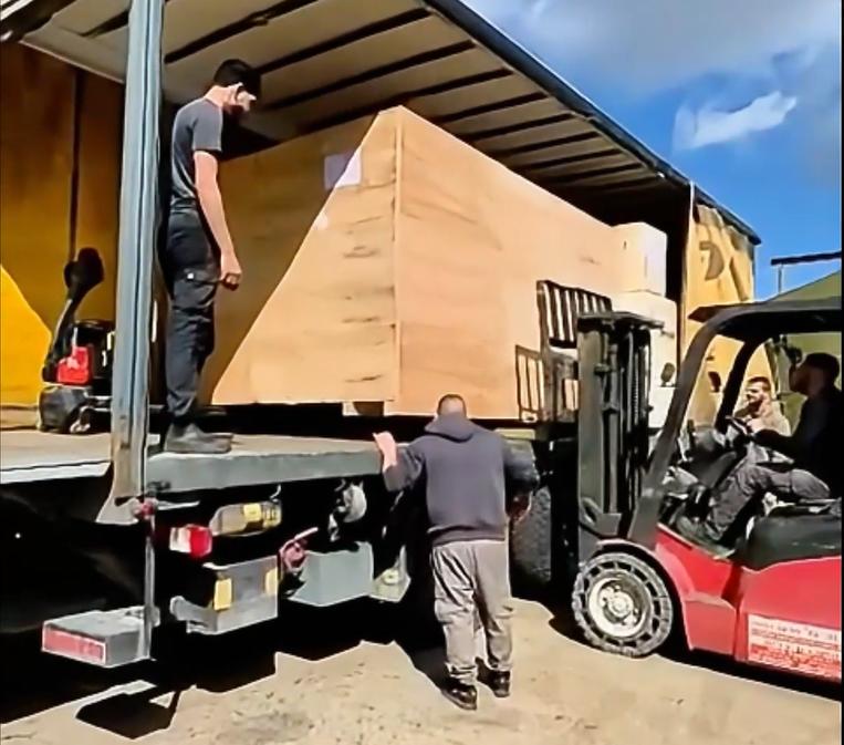 Unloading the crated machine at delivery